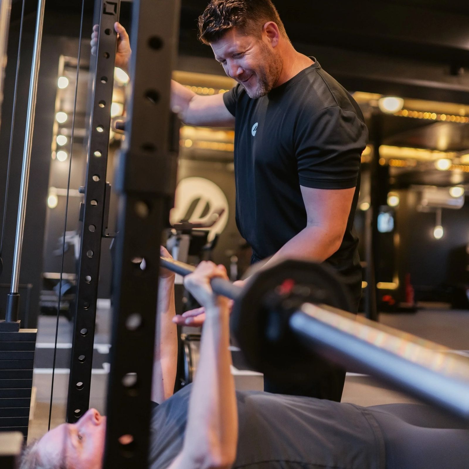 A coach spotting a bench press.