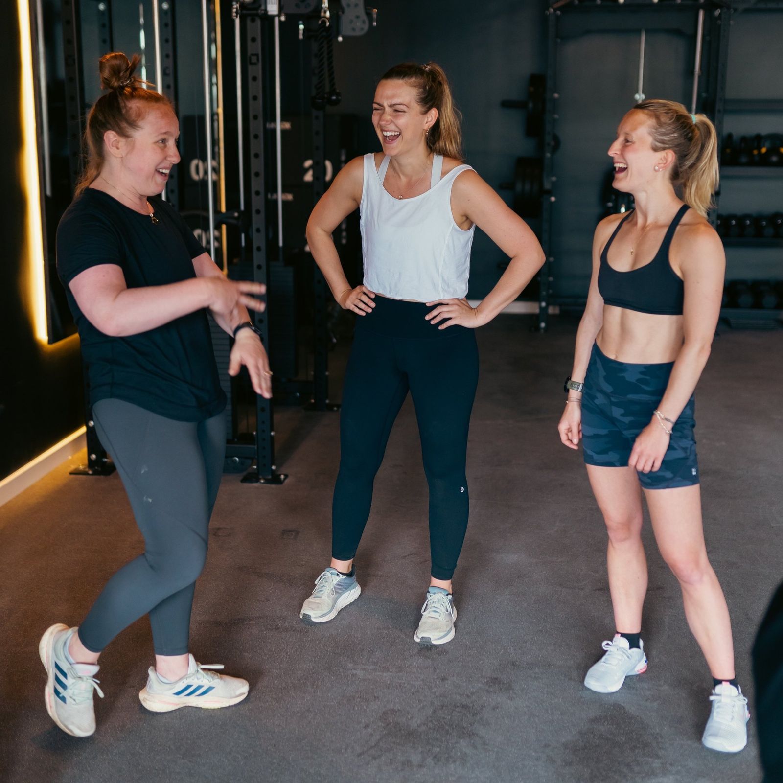 Three members laughing together between sets